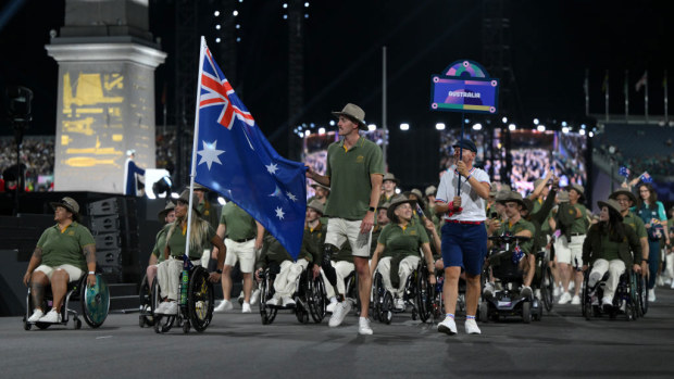 Madison De Rozario and Brenden Hall, Flag Bearers of Team Australia, hold their national flag.