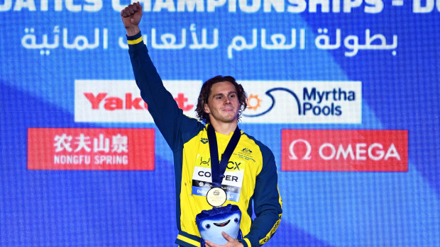 Isaac Cooper celebrates his gold medal at the World Aquatics Championships.
