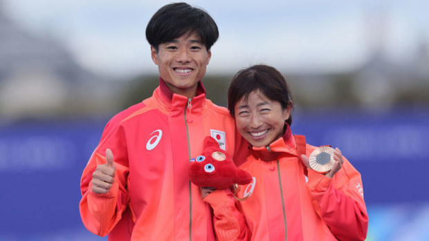 Bronze medalist, Misato Michishita of Team Japan and guide celebrate during the Women's T12 Marathon medal ceremony.