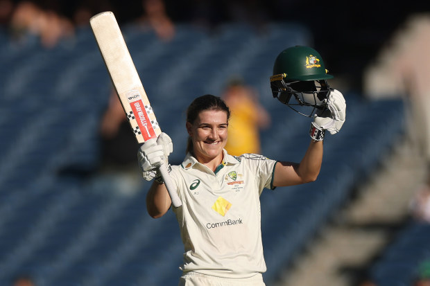 Annabel Sutherland celebrates with her bat at the MCG.