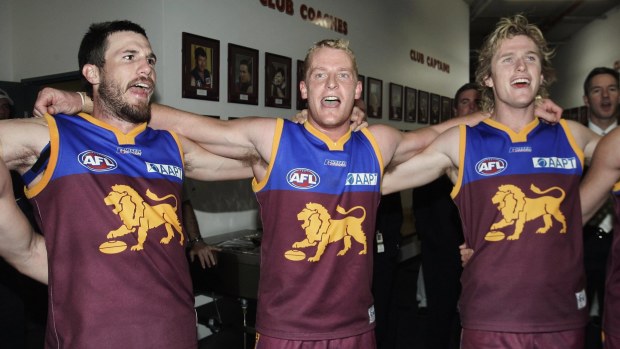 Michael Voss, Robert Copeland and Troy Selwood of the Lions rejoice after a win.