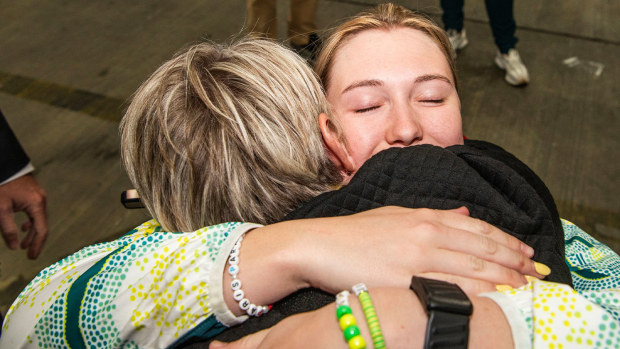 Chloe Osborn shares an emotional embrace with her mum Kerilyn after landing at Sydney Airport following the Paris Paralympics.