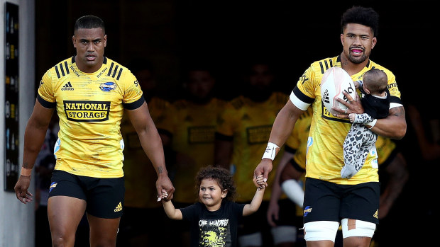 Ardie and Julian Savea of the Hurricanes walk out onto the ground at Sky Stadium.
