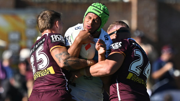 Cooper Bai is tackled during the 2025 NRL Pre-Season Challenge match between the Brisbane Broncos and the Gold Coast Titans.