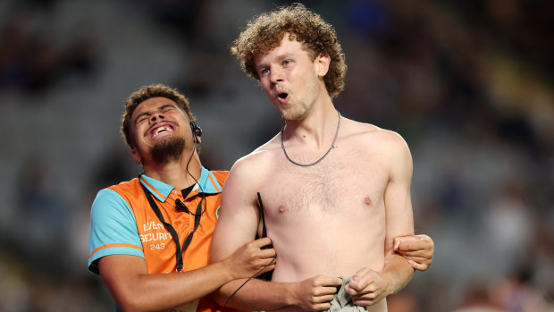 A pitch invader runs on to the field at Eden Park.