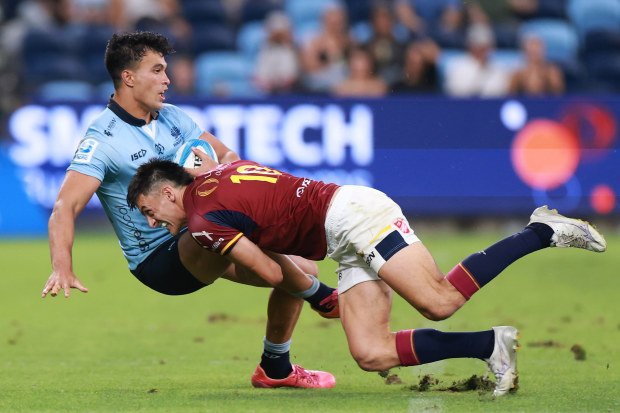 Taine Robinson of the Highlanders tackles Joseph-Aukuso Suaalii of the Waratahs.
