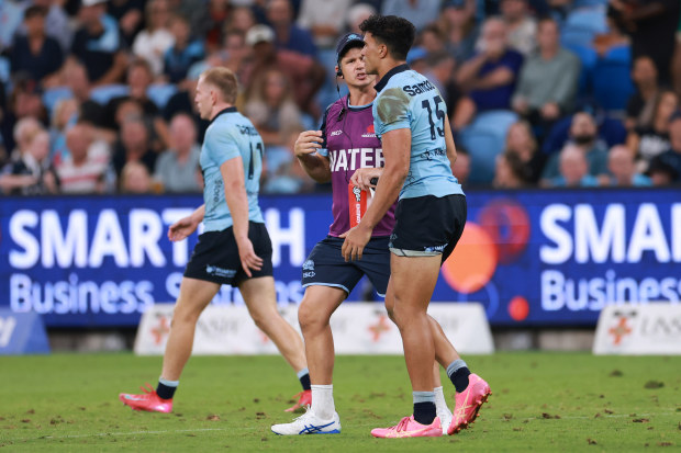 Joseph-Aukuso Suaalii of the Waratahs limps after a heavy tackle.