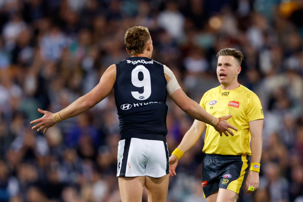 Patrick Cripps of the Blues argues with AFL Field Umpire, Nick Foot.