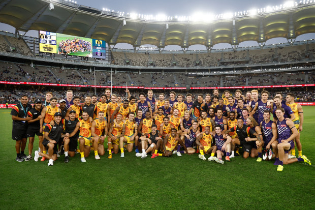 The All Stars and Dockers pose after the match.