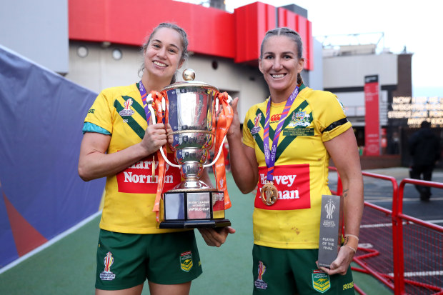 Kezie Apps and Ali Brigginshaw of Australia celebrate with the Women's Rugby League World Cup trophy and winners medals.