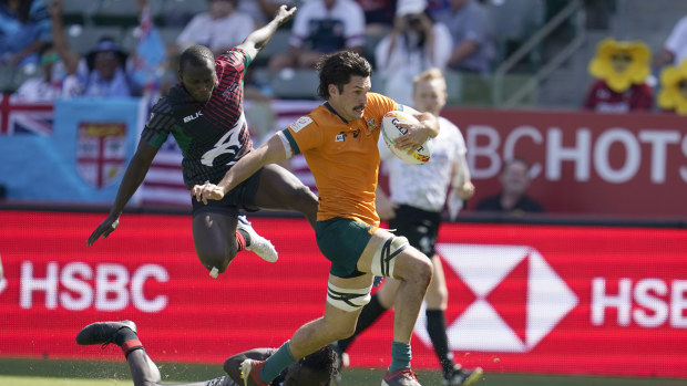 Australia's Henry Paterson evades the Kenyan defence to score a try.