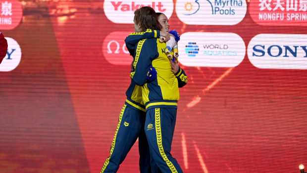 Alexandria Perkins and Matt Temple share the third step on the podium for the 100m butterfly at the World Short Course Championships.