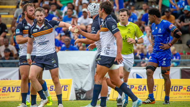 The Brumbies celebrate after scoring during their Super Rugby Pacific match.
