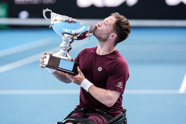 Alfie Hewett of Great Britain kisses the trophy.