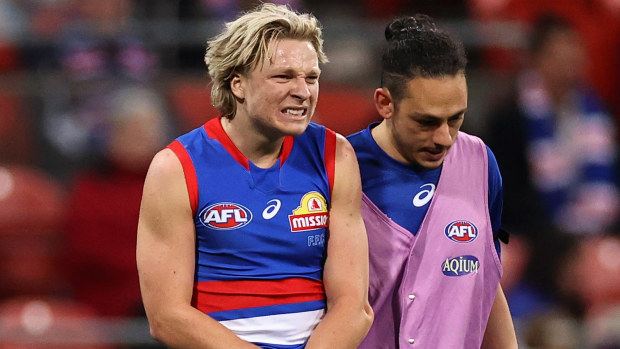 Cody Weightman of the Bulldogs leaves the field with a dislocated elbow during the round 14 AFL match between the GWS Giants and the Western Bulldogs. Photo: Cameron Spencer