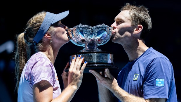 Olivia Gadecki and John Peers kiss the trophy after winning the mixed doubles title at the Australian Open.
