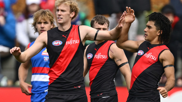 Tom Edwards of the Bombers is congratulated by Isaac Kako during their trial game.