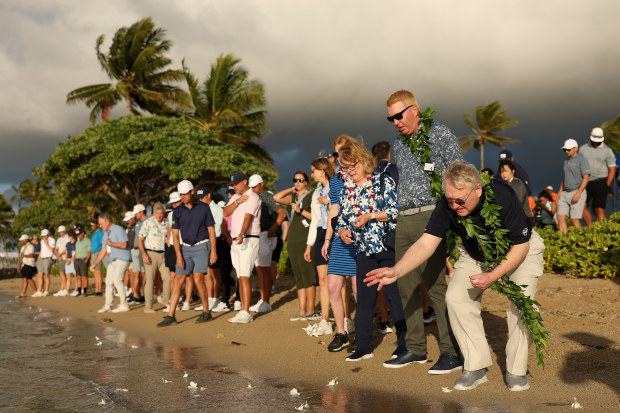 The family of Grayson Murray and members of the PGA community spread flowers prior to the Sony Open in Hawaii.