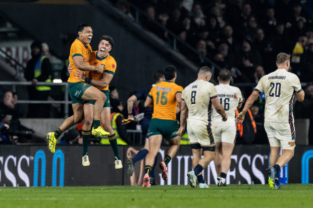 Australia's Len Ikitau and Ben Donaldson celebrate a late try scored by Max Jorgensen.