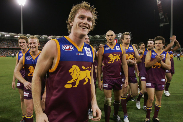 Troy Selwood of the Lions leads the team from the field after victory.