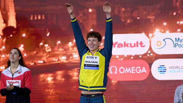 Max Giuliani stands on the podium following the men's 200m freestyle final at the 2024 World Short Course Championships.