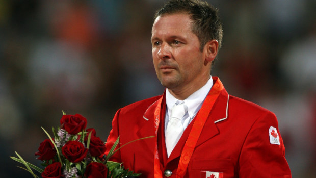 Eric Lamaze of Canada poses with the gold medal after he and his horse Hickstead won the Individual Jumping event at Beijing 2008. 