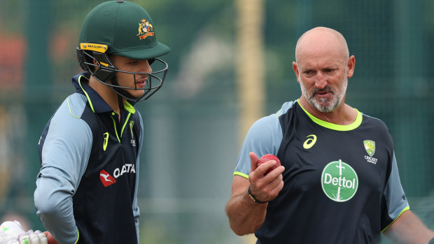 Sam Konstas of Australia speaks with batting coach Michael Di Venuto.