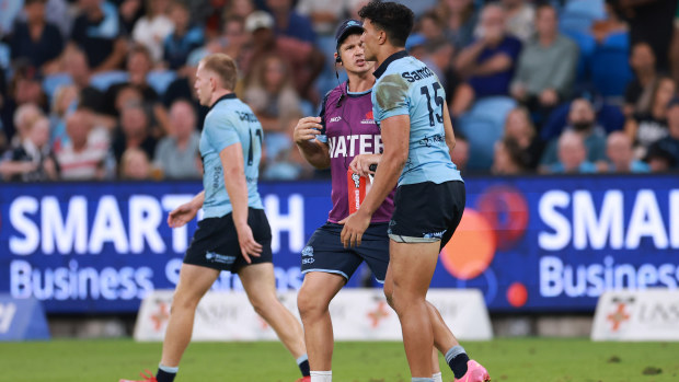 Joseph-Aukuso Suaalii from the Waratahs limps off after a strong tackle.