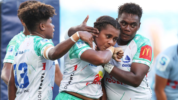 Josivini Naihamu of the Drua celebrates with team mates after scoring a try.