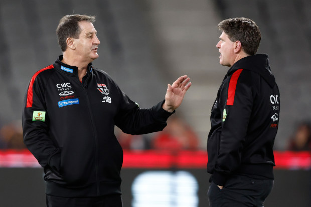 Ross Lyon, Senior Coach of the Saints speaks with assistant coach Robert Harvey.