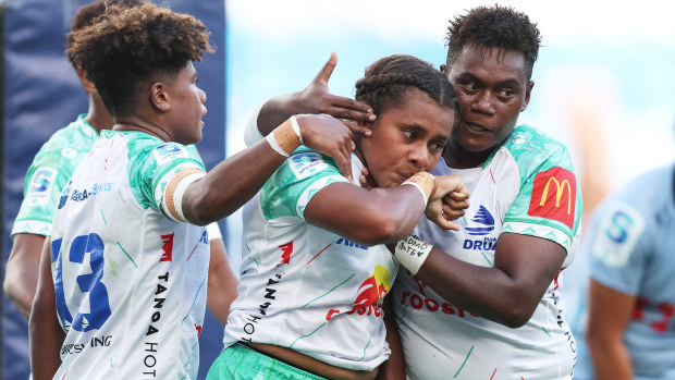 Josivini Naihamu of the Drua celebrates with teammates after scoring a try.