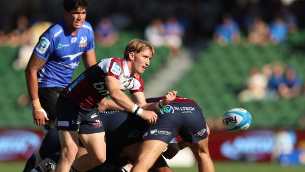 Tate McDermott of the Reds passes the ball.