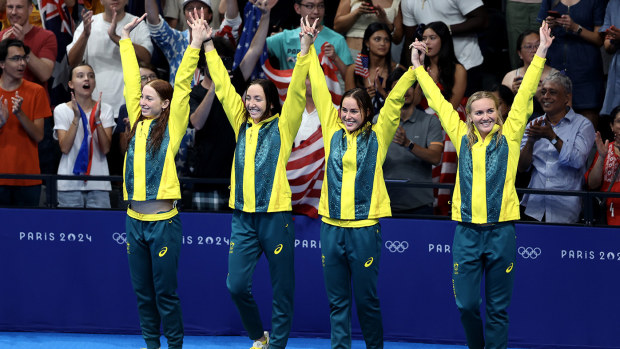 Gold Medalists Mollie O'Callaghan, Lani Pallister, Brianna Throssell, and Ariarne Titmus celebrate on the podium during the medal ceremony for the women's 4x200m freestyle relay final at the Paris 2024 Olympic Games.