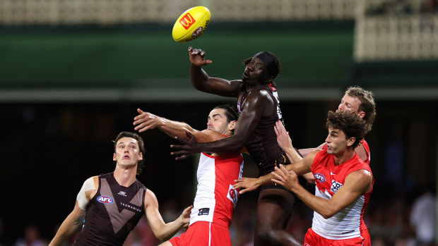 The Hawks' Mabior Chol and the Swans' Brodie Grundy contest a mark.