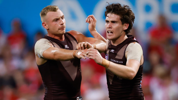 Will Day celebrates a goal with Hawthorn teammate James Worpel.