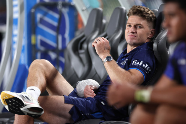 Beauden Barrett of the Blues on the bench with an icepack on his wrist.