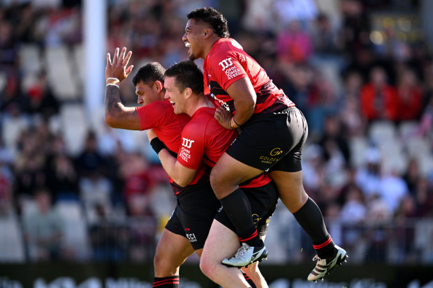 Levi Amua of the Crusaders celebrates with his team after scoring a try.