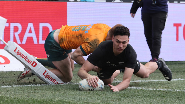 Shaun Stevenson of New Zealand scores a try.