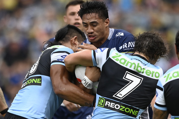 Murray Taulagi of the Cowboys in a tackle.