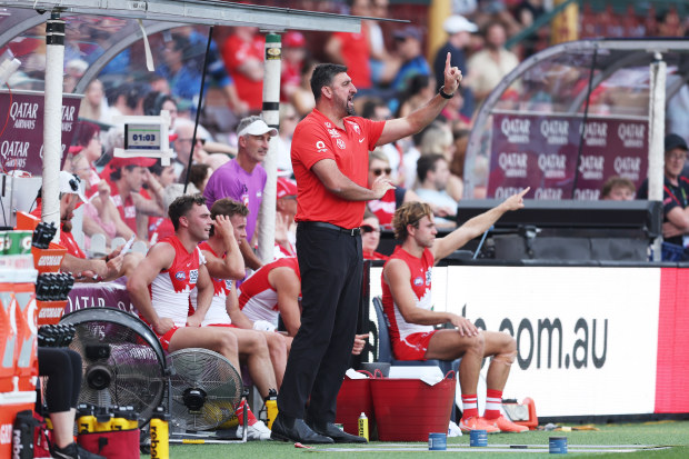 Sydney coach Dean Cox shouts orders from the boundary line.