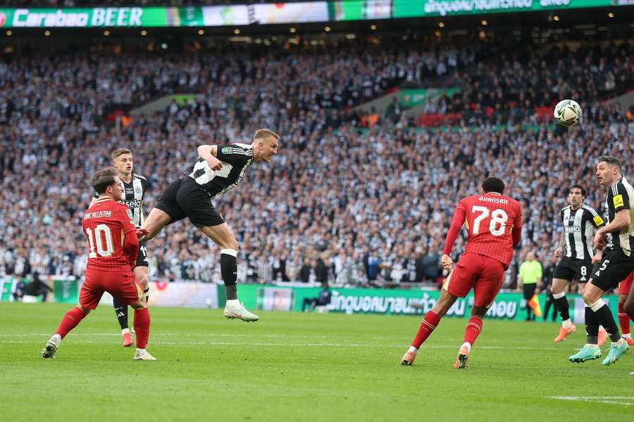 Newcastle's Dan Burn scores the first goal of the Carabao Cup final against Liverpool
