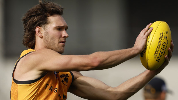 Jack Scrimshaw of the Hawks marks the ball during a training session.