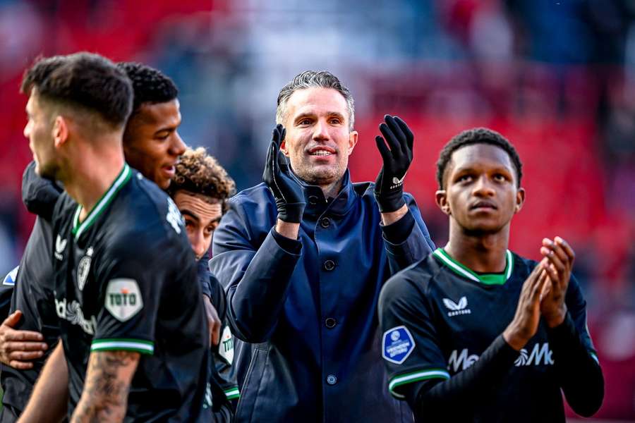 Feyenoord manager Robin van Persie applauds the away fans after his side's 6-2 win