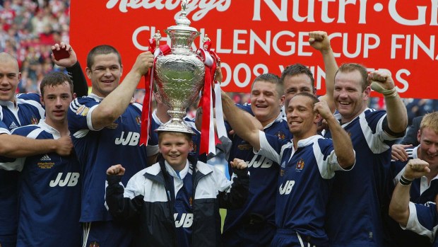 Andy Farrell of Wigan celebrates with the team and his son Owen.