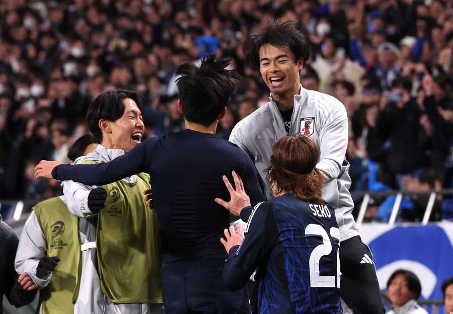 Japan's players celebrate their second goal