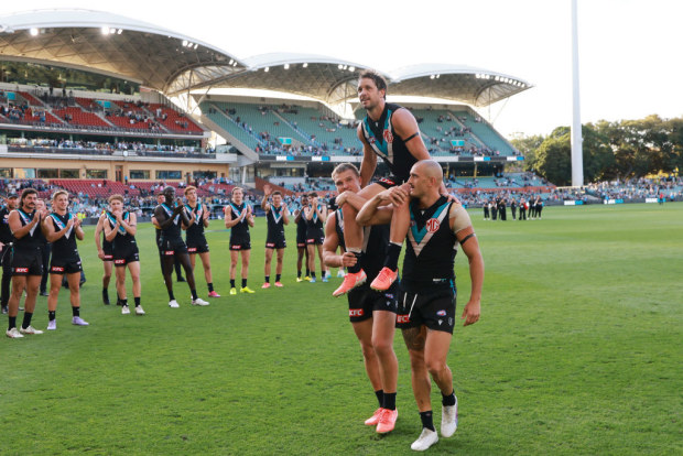 Travis Boak of the Power is chaired off by Ollie Wines and Sam Powell-Pepper after a record 393 games