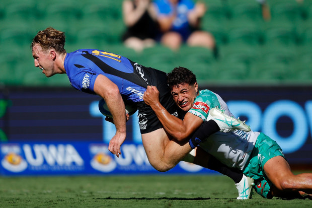 Harry Potter of the Force dives for the try line as Caleb Muntz of Drua tackles him.