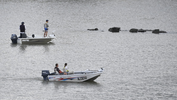 People fishing on the Fitzroy River in Rockhampton.