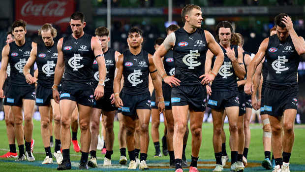 Carlton players trudge off.