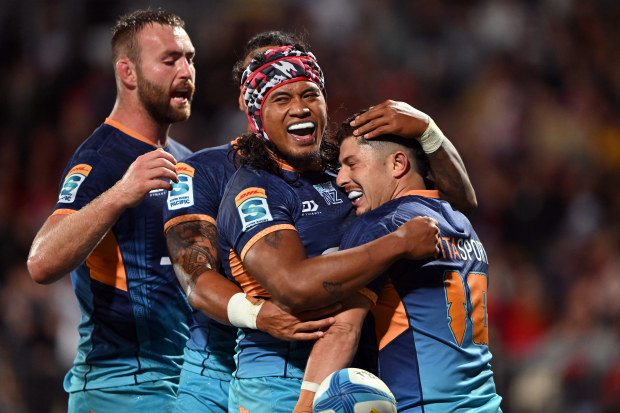 Patrick Pellegrini of Moana Pasifika is applauded by teammates after scoring a try.